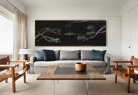 a large abstract canvas art hanging on the living room's wall