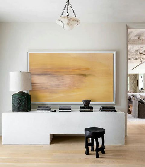 a large abstract canvas art hanging on the living room's wall