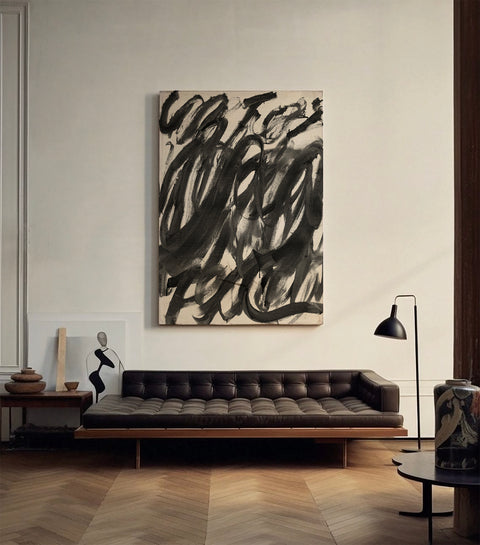 a large abstract canvas art hanging on the living room's wall