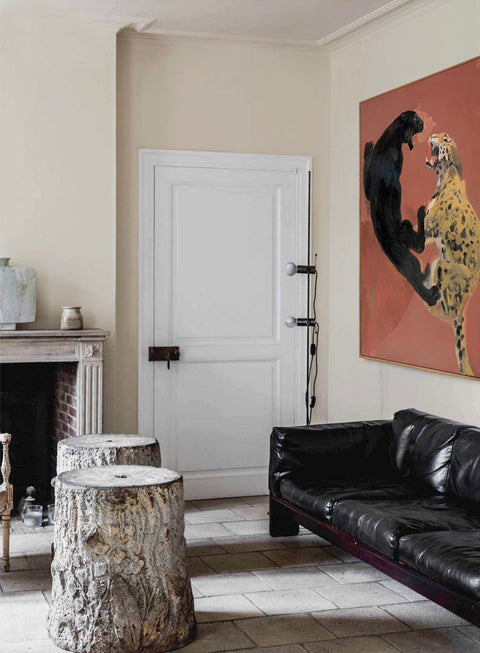 a large abstract canvas art of leopard hanging on the living room's wall