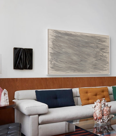 a large abstract canvas art hanging on the living room's wall