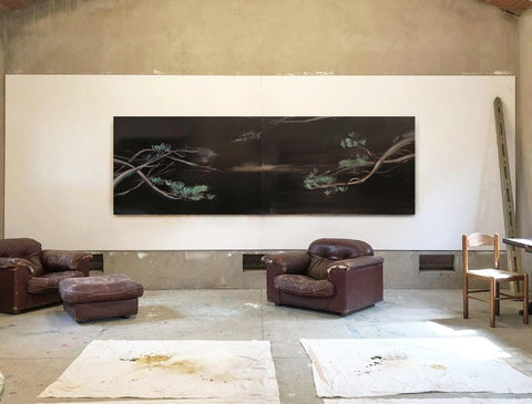 a large abstract canvas art hanging on the living room's wall