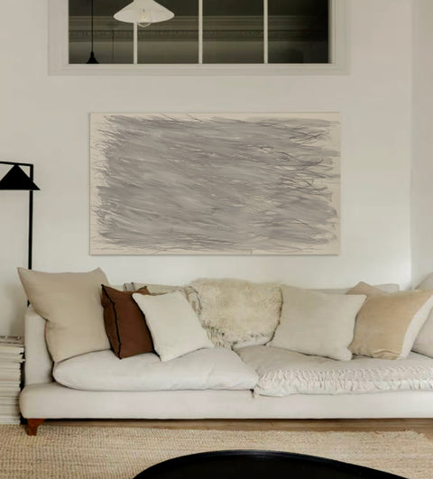 a large abstract canvas art hanging on the living room's wall