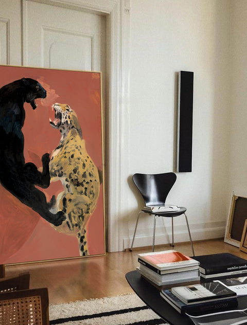 a large abstract canvas art of leopards hanging on the living room's wall