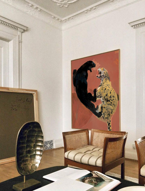 a large abstract canvas art of leopards hanging on the living room's wall