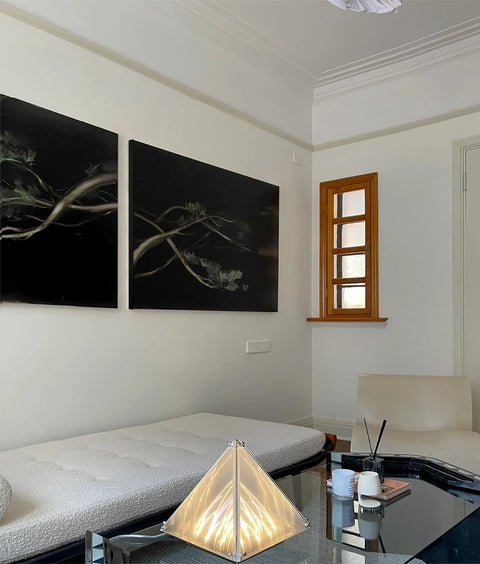 a large abstract canvas art hanging on the living room's wall