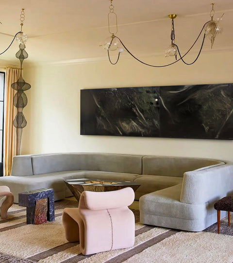 a large abstract canvas art hanging on the living room's wall