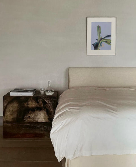 a large abstract canvas art hanging on the bed room's wall